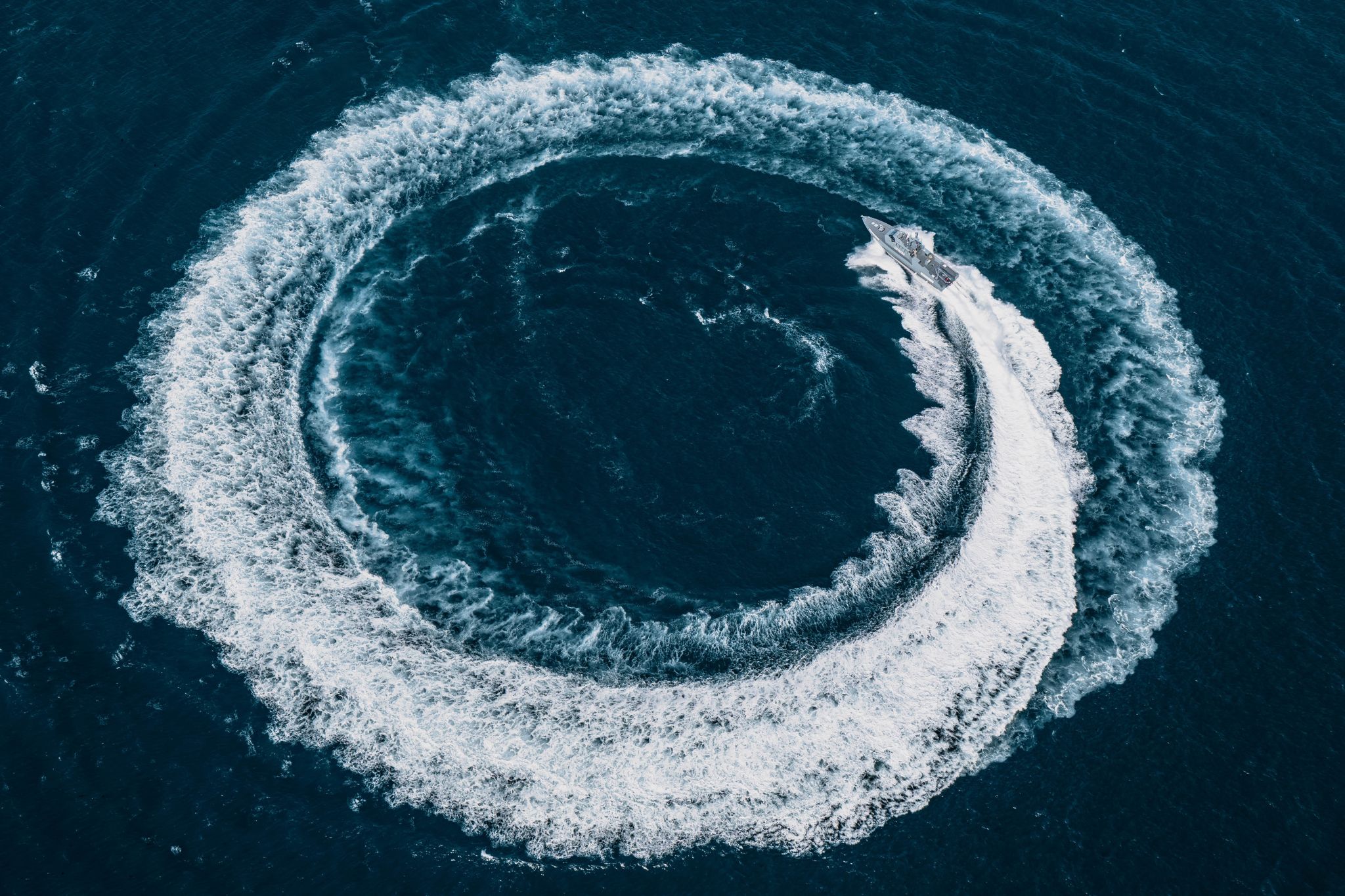 Aerial view of a high-speed interceptor circling at sea